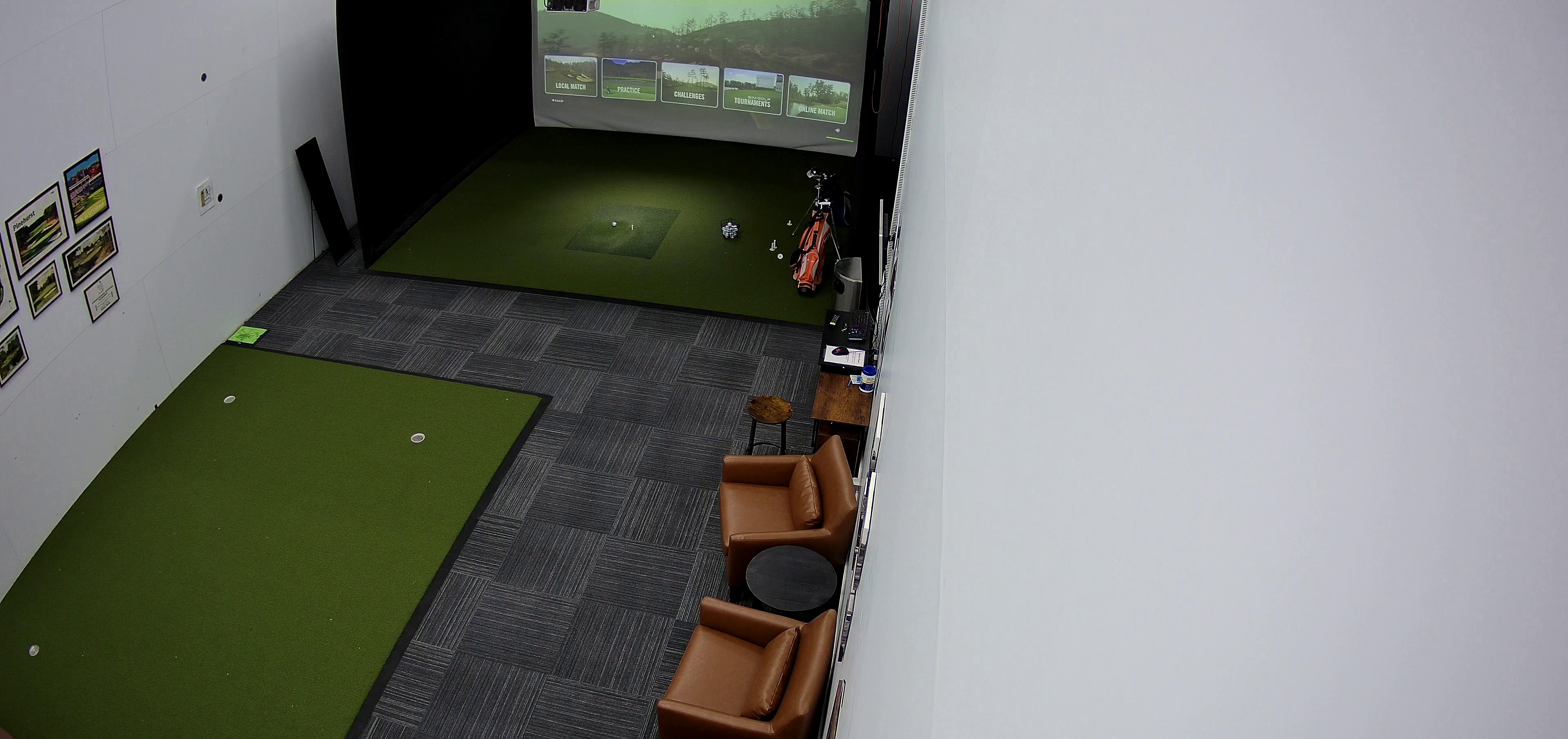 Indoor golf simulator setup at The Bay Club