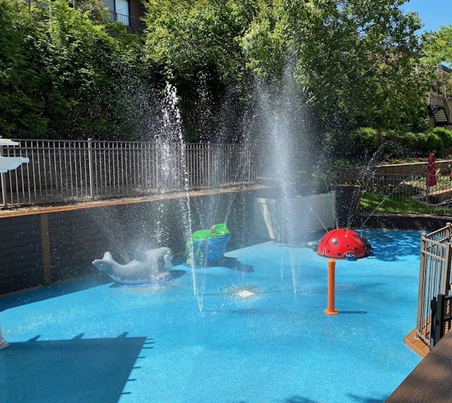 Children's splash pad and pool activity area